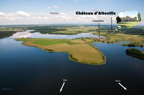 - une vue aérienne sur une île de golf dans un lac dans l'établissement Château D'Alteville, à Tarquimpol