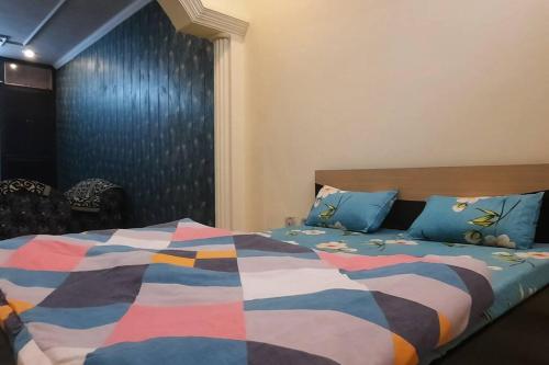 a bedroom with a bed with a colorful comforter at Yash's Congenial stays - 1 Rk independent place. in Lucknow