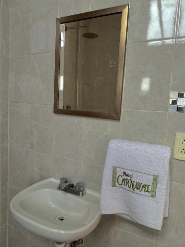 La salle de bains est pourvue d'un lavabo et d'une serviette. dans l'établissement OYO Hotel Museo Carnaval, à Huejotzingo