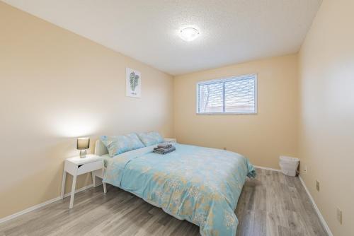 a small bedroom with a bed and a window at MT Pleasant NW 2 bedrooms 502 in Calgary