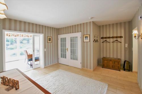 a living room with a door and a rug at Peace-Deluxe**** in Bingen am Rhein