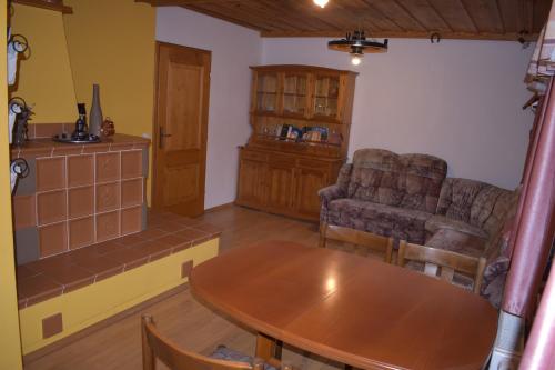 a living room with a table and a couch and chairs at Glamping Organic Farm Slibar in Tržič