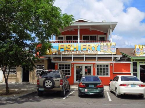 two cars parked in a parking lot in front of a fast food restaurant at Ocean Breeze Villa 242 in Nassau