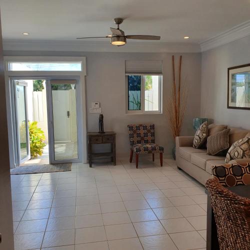 a living room with a couch and a table at Ocean Breeze Villa 242 in Nassau