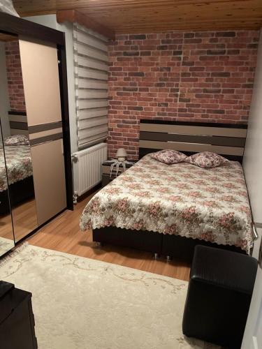 a bedroom with a bed and a brick wall at Daire in Istanbul