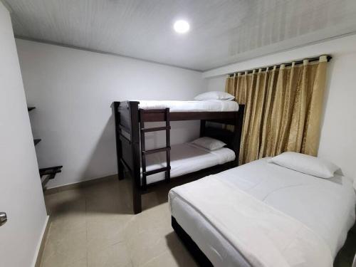 a bedroom with two bunk beds and a ladder at Casa Horeb in Salento