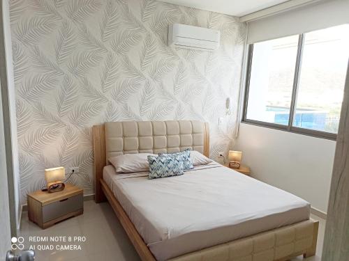 a bedroom with a bed and a wall at Best Luxury Samaria in Santa Marta