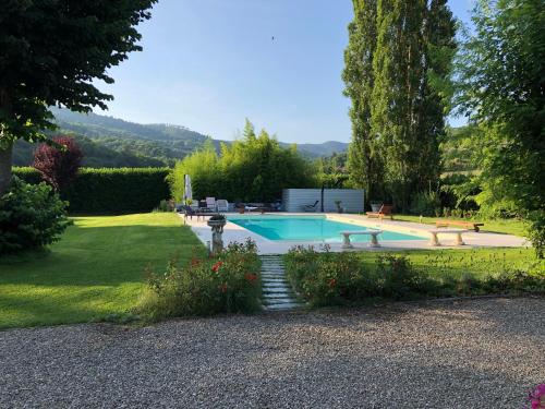 a swimming pool in the yard of a house at Villa Giuliana in Arezzo