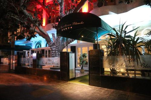a store front with plants in front of a building at Hôtel La Maison Blanche in Tunis