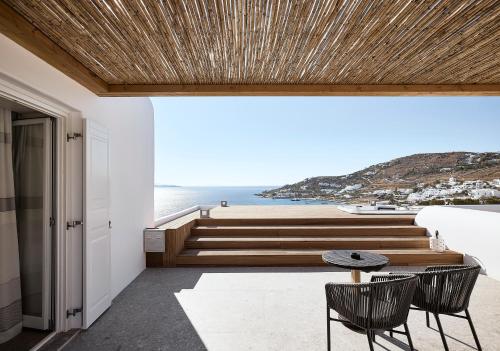 a house with a view of the ocean at Amazon Mykonos Suites & Spa in Agios Ioannis Mykonos