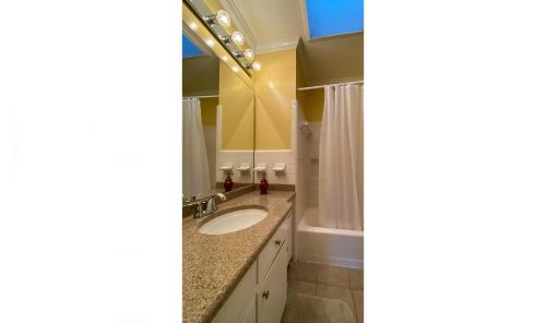 a bathroom with a sink and a mirror at HOLLYBOURNE II home in Jekyll Island