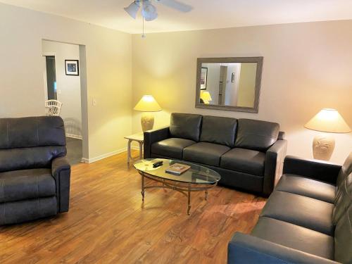 a living room with a couch and a coffee table at HERON COTTAGE home in Jekyll Island