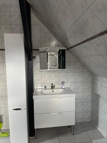 a bathroom with a sink and a mirror at Appartement Plaga in Varel