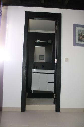 a bathroom with a sink and a mirror at Refugio no Campo - AL 1683 in Rapoula do Côa