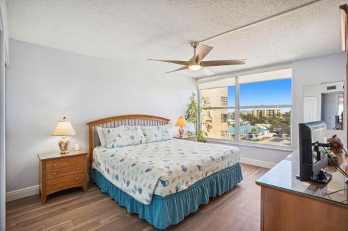 a bedroom with a bed and a large window at Madeira Vista 601 in St. Pete Beach