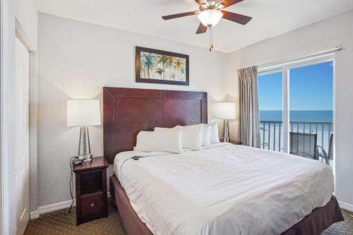 a bedroom with a bed and a large window at Sunset Vistas 603W in St Pete Beach