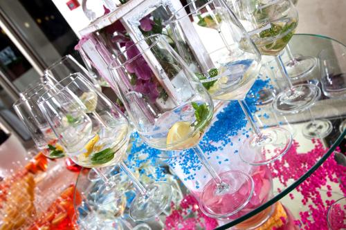 a bunch of wine glasses on a glass table at Hotel Terme Abano Verdi in Abano Terme