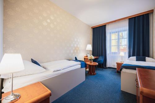 Postel nebo postele na pokoji v ubytování Hotel U Královny Elišky