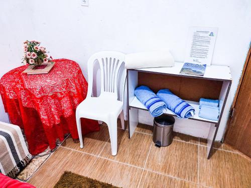 a desk with a chair and a table with pillows at Casa da Debora in Lençóis