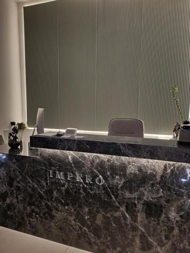 an office with a black counter top with a desk at Impero Nafplio Hotel & Suites in Nafplio