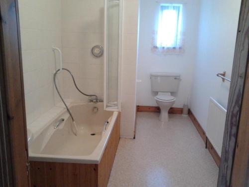 a bathroom with a tub and a toilet at Westland Apartment No. 1 in Ardea