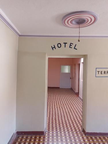 a hotel room hallway with a hotel sign on the wall at Auberge Restaurant Rooftop Tamazirt in Boumalne
