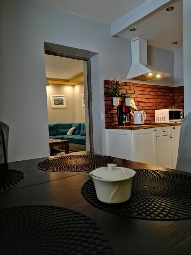 a kitchen with a table with a bowl on top of it at GOLD apartamenty & spa in Szczawnica