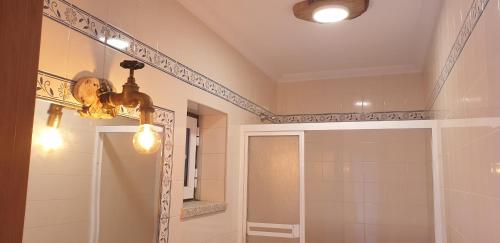 a bathroom with a shower and a mirror at Segredos da Montanha by RetiroDoResende - Quarto Isolado in Seia