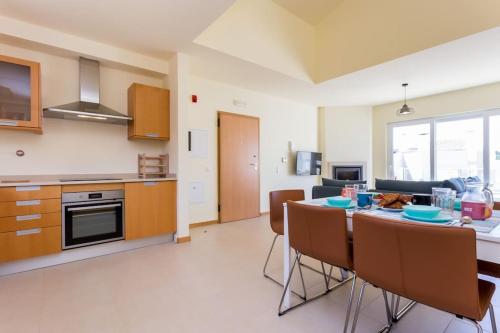 a kitchen and dining room with a table and chairs at Burgau 2floor appt in condominium w/ shared pool in Burgau