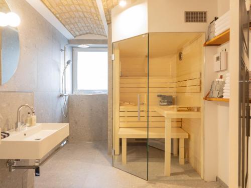 a bathroom with a shower and a sink and a tub at OSTKÜSTE - Villa Groth Design Apartments in Heringsdorf