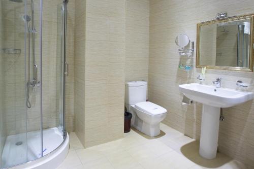 a bathroom with a toilet and a sink and a shower at Diamond Hotel Yerevan in Yerevan