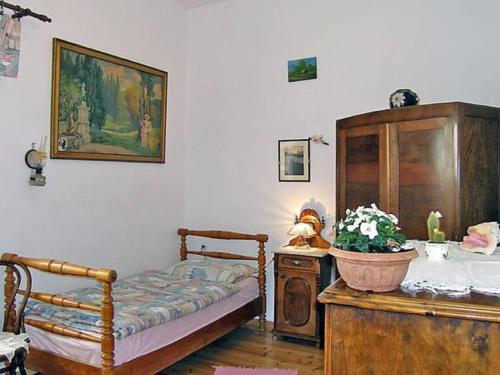 a bedroom with a bed and a cabinet and a plant at Apartment Milka in Vinjerac