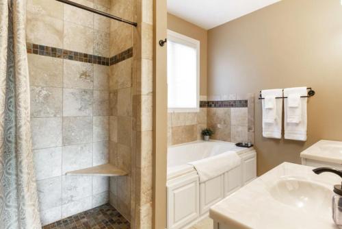 a bathroom with a tub and a sink at Cedar House Retreat in Excelsior