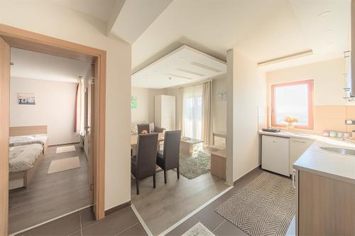 a room with a kitchen and a dining room at Modern Lux Apartment H8 at Milmari Resort in Kopaonik