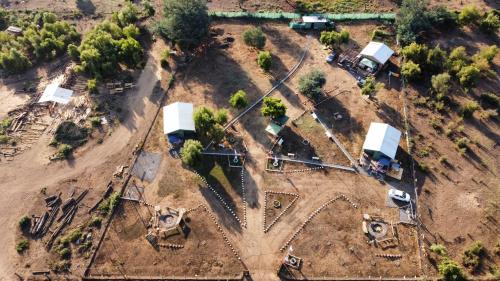 an aerial view of a farm with a cross at Cabañas Vista Hermosa Radal 7 Tazas in El Torreón