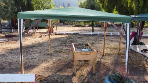 a green canopy over a play table in a park at Cabañas Vista Hermosa Radal 7 Tazas in El Torreón