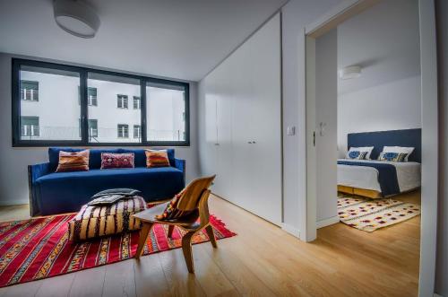 a living room filled with furniture and a blue rug at Lisbon Serviced Apartments - Liberdade in Lisbon