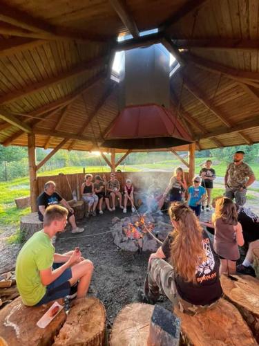 a group of people sitting around a camp fire at Areál Ontario Kyselka in Kysibl Kyselka