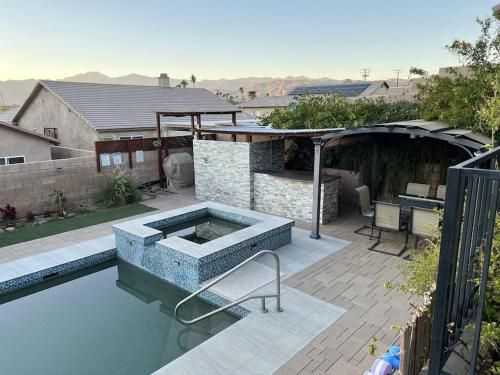 a swimming pool with a chair next to a house at Miracle mineral water pool and spa in Desert Hot Springs