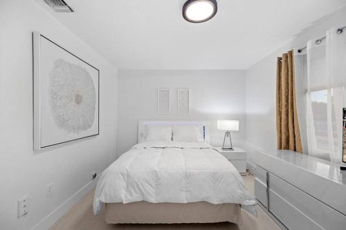 a white bedroom with a bed and a window at Beautiful Apartment in the Heart of Miami Apt 3 in Miami