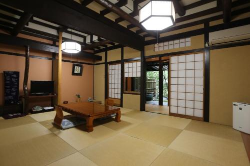 a room with a table in the middle of it at Momijiya Annex in Kyoto