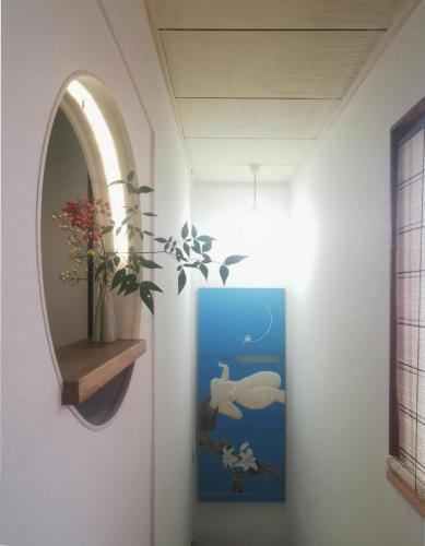 a hallway with a mirror and a painting on the wall at 心遊亭Shin Yu Tei 一軒雅宿 in Kanazawa