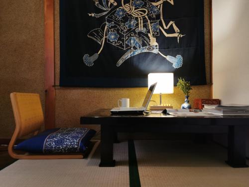 a desk with a laptop and a lamp on it at 心遊亭Shin Yu Tei 一軒雅宿 in Kanazawa