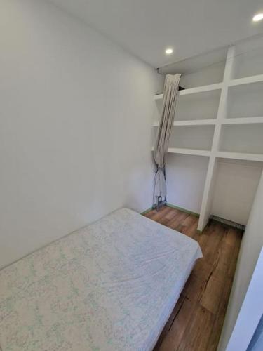 a small room with a bed and a window at T1 BIS 1 chambre in Saint-Étienne