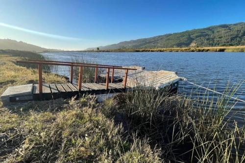 a dock on the side of a body of water at Cabañas Borde Lindo in Valdivia