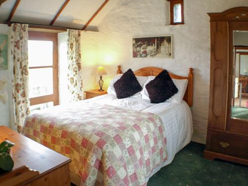 a bedroom with a large bed and a window at The Mealhouse-UK12902 in Pelynt
