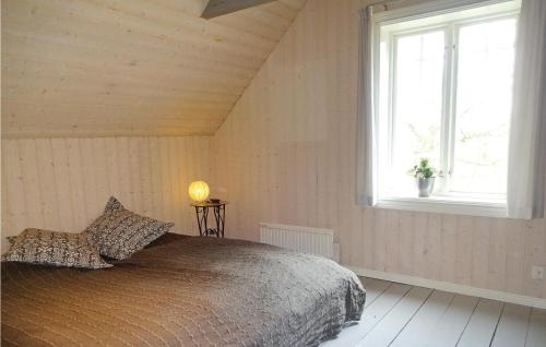 a bedroom with a bed and a window at 2 Bedroom Amazing Home In Markaryd in Markaryd