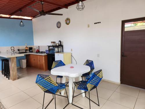a kitchen with a white table and blue chairs at Apartamento Africa in Palenque