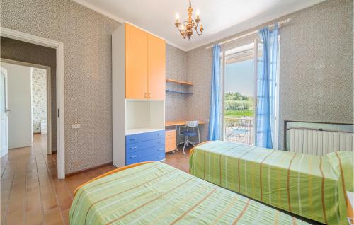 a bedroom with two beds and a desk at Nice Home In Asti With Jacuzzi in Asti