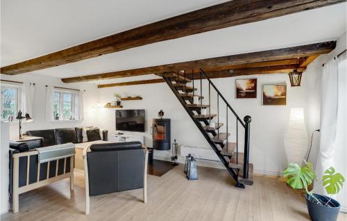 a living room with a spiral staircase in a house at Nice Home In Erslev With Wifi in Erslev